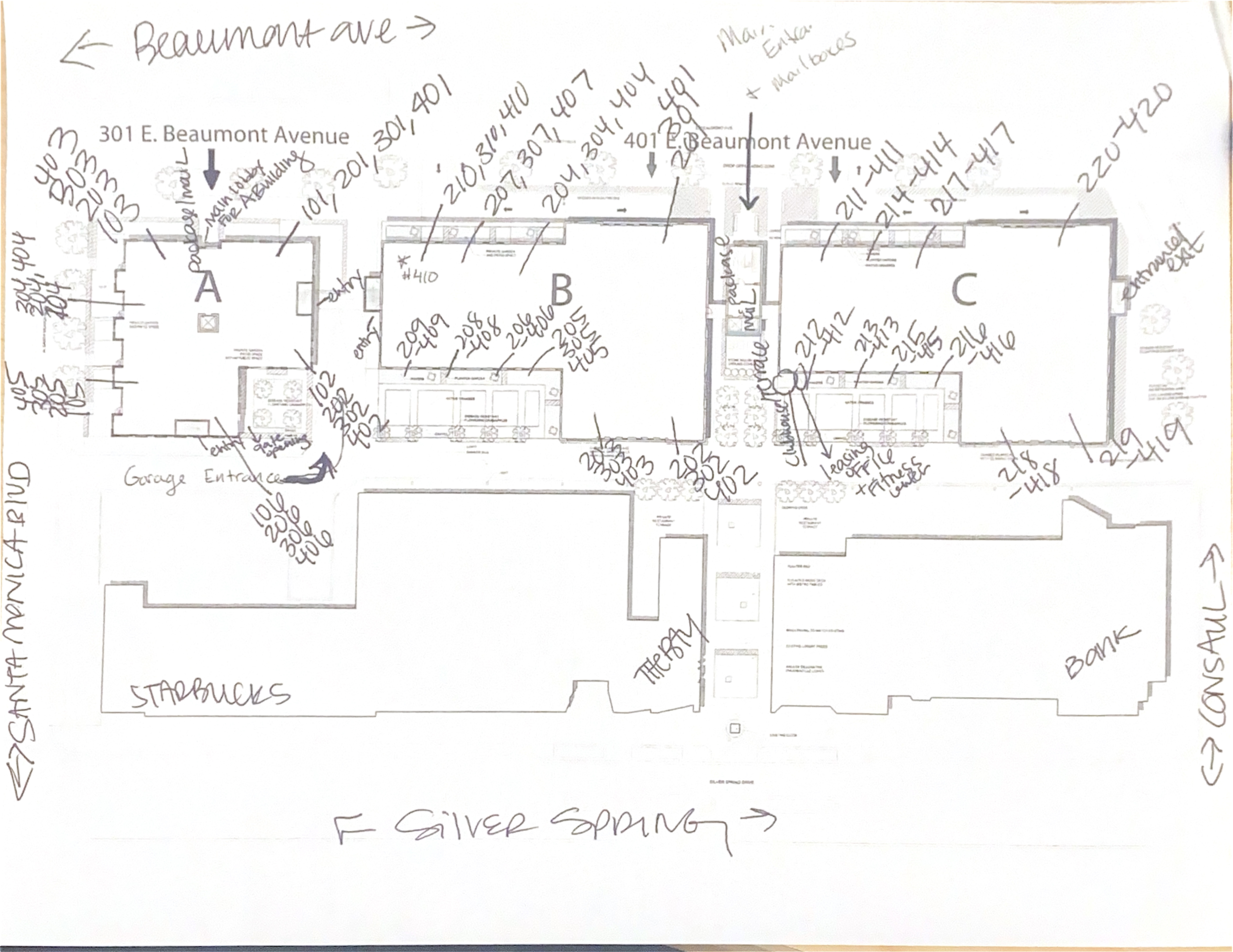 Hand-drawn floor plan with unit numbers and street orientation
